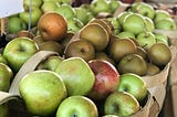 A variety of apples in a fresh produce market