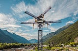 Photo of energy storage crane with Alps in background