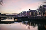 Liffey river in Dublin with city skyline at dusk