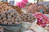 Different potato varieties on onions for sale at a market in Peru