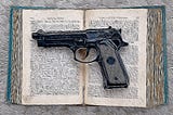 A handgun on an open book