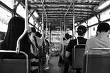 Riders on the Hong Kong tram in black and white