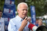 Joe Biden addresses a crowd using a bullhorn.