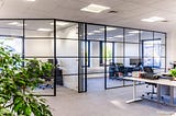 How can aluminium-framed glass partitions give aesthetic appeal?