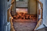 An abandoned house with a hole where the back door should be. Image by Frank Winkler from Pixabay