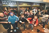 Customers rushing into a retail store during Black Friday