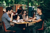 Three people discussing a business plan.