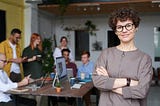 A woman with glasses at a team meeting