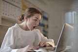 woman gasping at her laptop screen