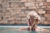 Older woman in hot springs water. Aging well.