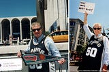 Regis Philbin standing in front of the Lincoln Center wearing a David Robinson 50 jersey and holding a San Antonio Spurs Banner with the Statue of Liberty in the background.