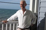 Author standing on his balcony with the beautiful Indian Ocean in the background