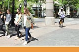 People walking, biking in streets of Uptown Charlotte