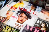 Photograph of a stack of Vogue magazines.