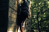 author climbing rock wall