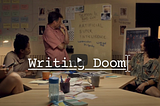 Four writers arranged around a table looking at the lead writer who are all perplexed about writing a TV season using Artifical SuperIntelligence as a good or bad actor