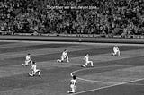 ITV black and white ad shows players kneeling and caption “together we will never lose”