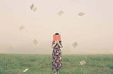 A dream scene shows a woman standing in the middle of a grass field, hiding her face behind a book while the pages fly away.