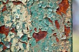 A rusting pall behind peeling paint