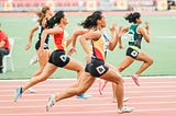 women running in a track and field compeition
