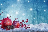 Snowy Christmas scene with red ornaments, pine cones, and red berries shining against a bluish night sky.