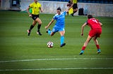 women playing football