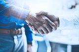 Two people shaking hands, symbolizing trust