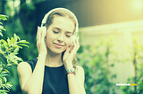 A woman with headphones on and relaxing