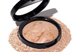 Laura Geller Baked Balance-N-Brighten Foundation in compact, offering a natural, radiant finish for flawless skin tone correction and lasting coverage.
