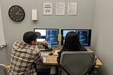 Two of our engineers talking through some code during a pairing session