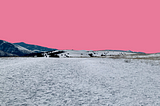 photo of an icy trail with mountains in the background