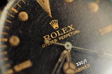 Old Rolex dial macro with gilt logo and spider (cracked) texture
