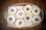 A gold-rimmed antique serving tray with jammy dodgers