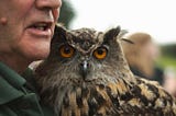 Image of an eagle owl held by a man. Not Flaco. Photo by Matt