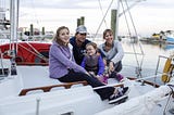 Christel & Jarad Astin with their children, Arden and Riley, on their boat named Catherine. -Will Figg for the New York Times