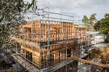 A timber frame of a three storey building under construction