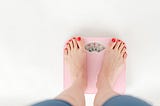 A woman’s feet on a weighing machine