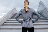 Woman staring up at steps ahead of her