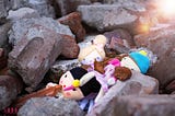 children’s toys amid the rubble of cement
