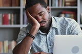 man asleep at laptop