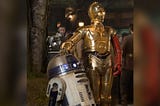 An image of R2-D2 and C3PO standing next to each other, an image still taken from the movie Star Wars.