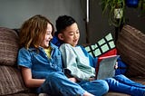 Two children doing home school work together