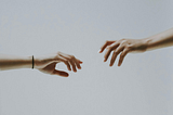 Hands Reaching Out To Eachother