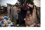 Slums are such densely populated areas that lack or have no basic utilities such as…