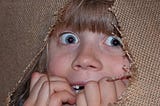 Frightened girl hiding behind burlap. Image from PickPix. https://www.pickpik.com/person-human-girl-child-eyes-face-52699