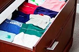 AI generated image of folding clothes in a dresser drawer