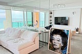 A painting of Marilyn Monroe leaning against the wall of a condo