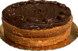 A yellow layer cake with chocolate frosting on the top only.