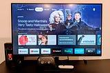 Picture of a smart computer monitor with Google TV landing home page displayed. In the bottom row of apps, the Google Stadia app is visible and installed.