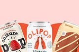 A can of culture pop strawberry, Olipop vintage cola, and poppi root beer